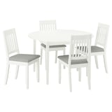 Modern white round dining table & 4 chairs. Cushioned seats, clean lines.