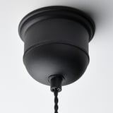 Black pendant lamp with woven design hangs from ceiling, showcasing high-quality craftsmanship and modern style.
