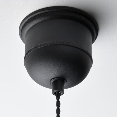 Black pendant lamp with woven design hangs from ceiling, showcasing high-quality craftsmanship and modern style.
