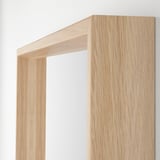 Light wooden-framed mirror, well-made, clean cut, and polished.