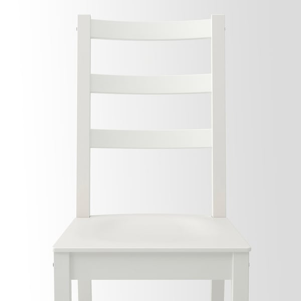 Comfortable white wooden chair with deep seat and high back for good support.
