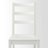 Comfortable white wooden chair with deep seat and high back for good support.