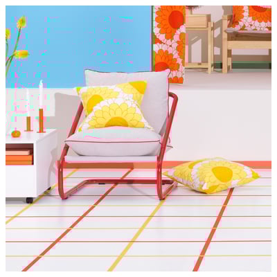 Red metal-framed lounge chair with beige cushions, minimalist design by charlotte rude and hjördis olsson-une.