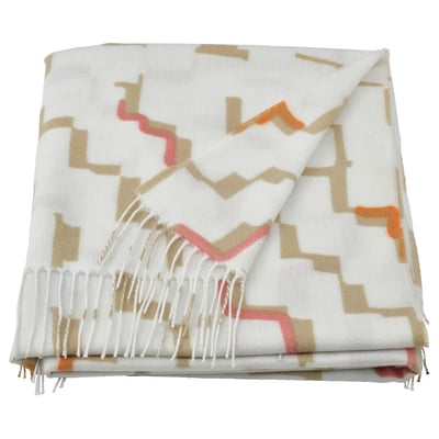 Folded OLIVSPINNMAL throw blanket in off-white with orange, brown, and grey geometric patterns, tasseled edges. Made from recycled polyester.