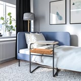 Modern bedroom with blue sofa and adjustable olse verko laptop table.