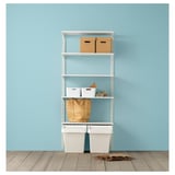 White metal shelving unit against blue wall with storage bins and boxes.