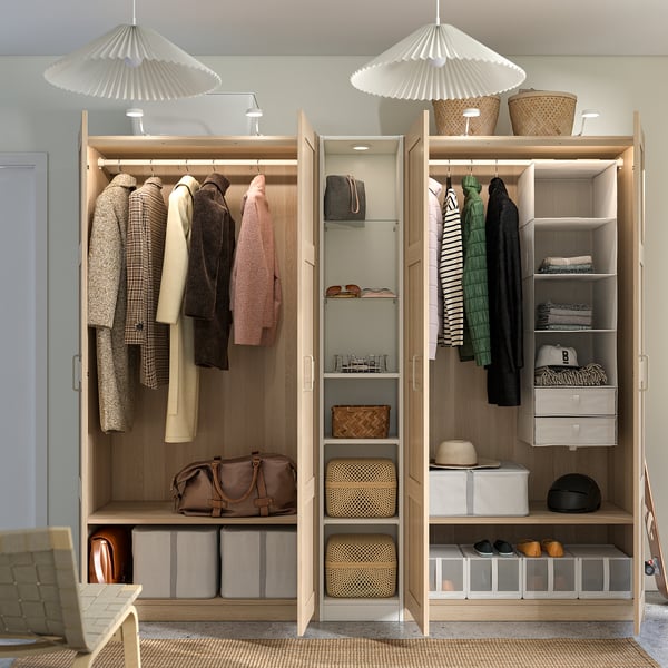 Organized wardrobe with hanging clothes, shelves, and storage boxes. Hinged doors and integrated lighting.