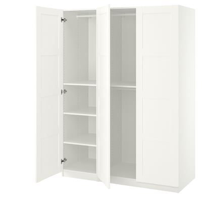 A white ikea PAX wardrobe with open doors, revealing empty shelves inside. Its minimalistic and modern, ideal for storage.