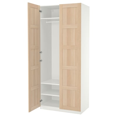 Ikea PAX wardrobe, white with light oak doors, standing open showing shelves.