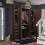 Modern hallway wardrobe with open doors revealing clothes, shelves, and hanging space. It has adjustable feet and built-in lighting.