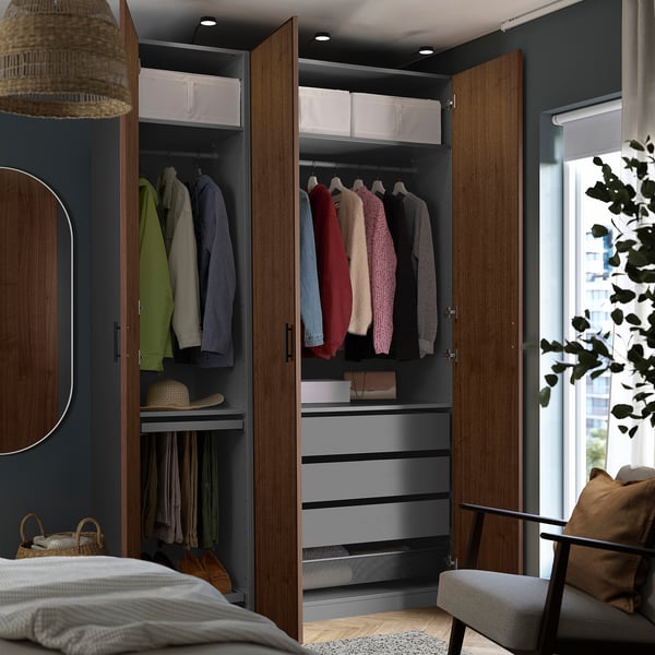 Open wardrobe displaying hangers, drawers, and clothes organized inside.