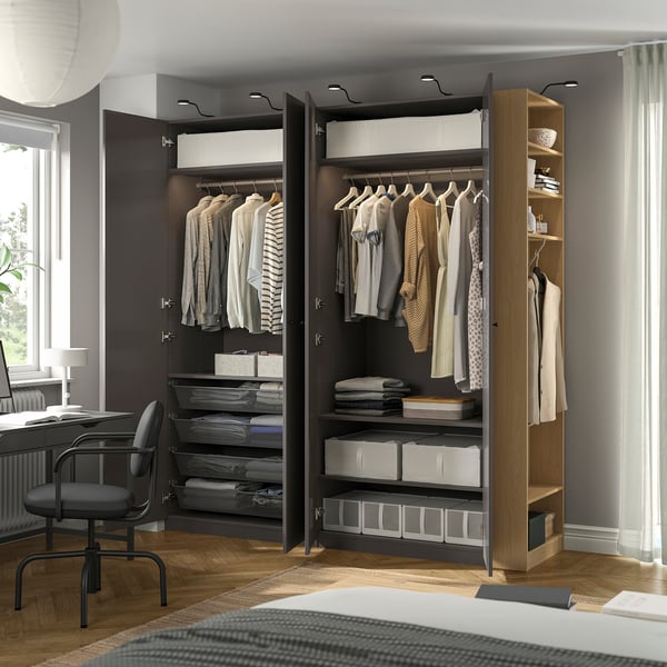 A modern wardrobe with hanging clothes, folded items, and storage boxes. Adjustable feet, integrated lighting, and a 10-year guarantee.