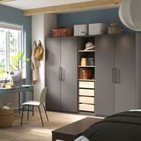 Modern bedroom with large gray PAX wardrobe, desk, and chair.