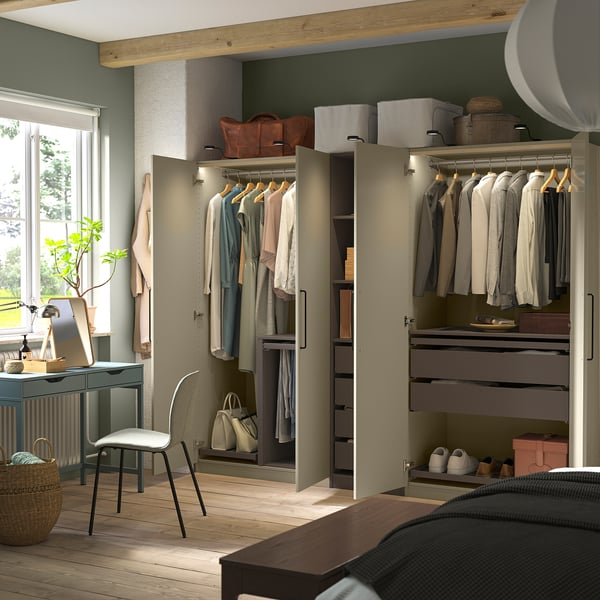 Walk-in closet with open and closed storage, lit interior.