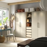 Bedroom with PAX wardrobe, desk, and storage.