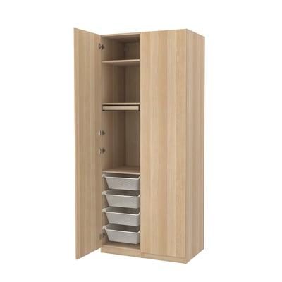 An open wooden PAX wardrobe with shelves and mesh baskets.