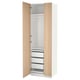 White and wood-textured PAX wardrobe. It has multiple drawers and compartments, standing vertically. A sleek, modern design.