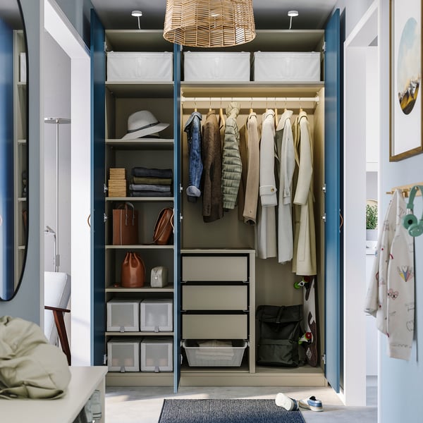 Organized wardrobe showcasing PAX system, featuring shelves for folded clothes, hanging rack, and storage boxes.