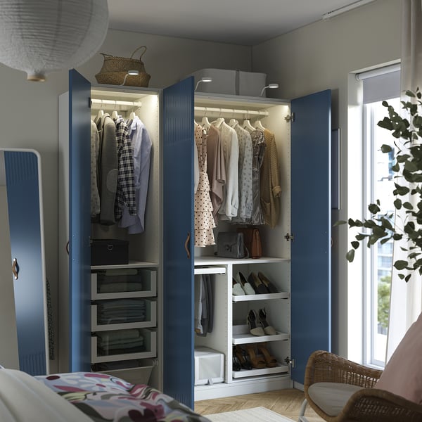 Blue wardrobe, open, reveals organized clothing. Hangable storage, shelves, led light, and shoe racks visible.
