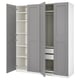 A grey ikea PAX wardrobe with open doors, revealing shelves and drawers inside.