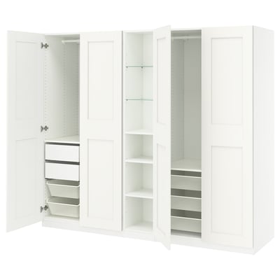 This image shows a white IKEA PAX wardrobe with open drawers and shelves. It a minimalist design for organizing clothes and accessories.