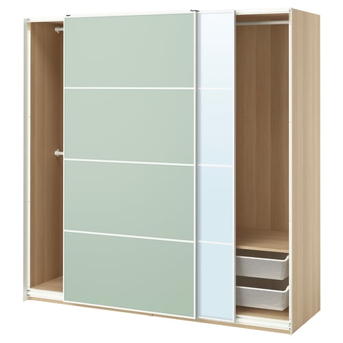 This image shows an open light green and white ikea PAX wardrobe, displaying its interior storage with wooden shelves and mesh baskets.