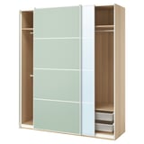 An open ikea PAX wardrobe with light green and white sliding doors, light wood interior, and mesh baskets.