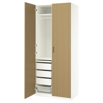 White & oak ikea PAX wardrobe with adjustable doors, shelves, drawers, and clothing rail.