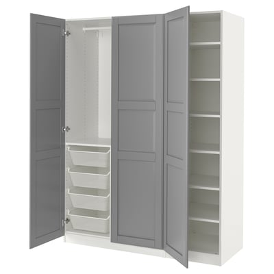 An open white and grey IKEA PAX wardrobe with shelves and mesh baskets.