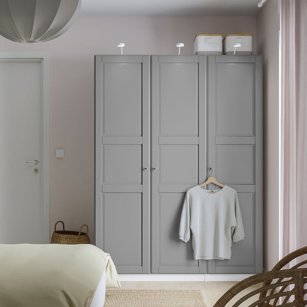 Gray PAX wardrobe with shirt, basket, sleek design.