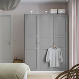 Gray PAX wardrobe with shirt, basket, sleek design.