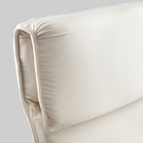 Close-up of a beige armchair cushion, showcasing its plush, textured fabric and sturdy seam stitching, emphasizing comfort and quality.