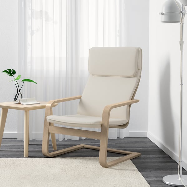 A light wooden armchair with beige cushions offers comfort with back and neck support, suitable for any room.