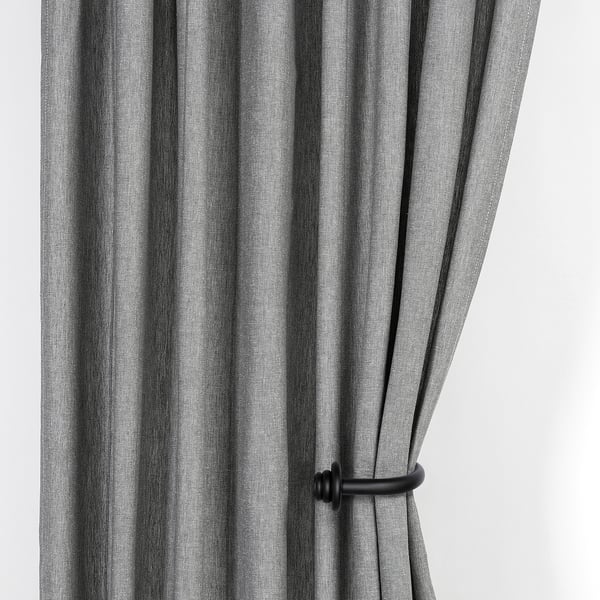 Black striped curtains held open by wooden tie-backs, showcasing their functional and decorative design.