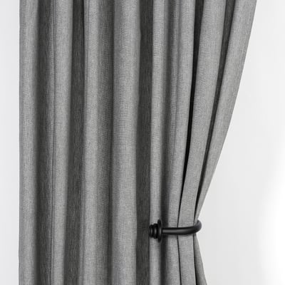 Black striped curtains held open by wooden tie-backs, showcasing their functional and decorative design.