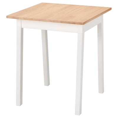 A white and light wooden square dining table from IKEAs PINNTORP series, featuring a simple, rustic design.