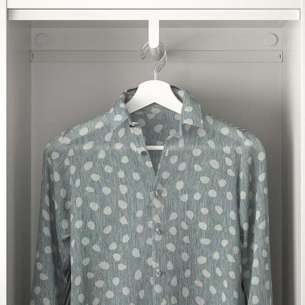A polka dot shirt hangs on a hanger inside a gray wardrobe, demonstrating storage functionality of the PLATSA system.