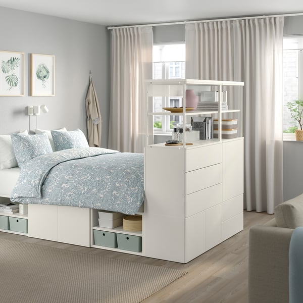 Modern white PLATSA bed with storage, large window.