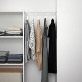 Modern closet with hanging clothes organizer, shelves, and folded items. Adjustable hanging rod and secure wall attachment.