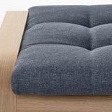 Close-up of a modern, cushioned bench with wooden frame, high-quality upholstery.