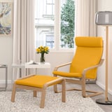 Bright yellow POÄNG chair & footstool in cozy corner. Modern, comfy, small setup with side table and lamp.