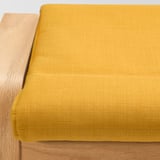 Close-up of yellow fabric cushion on wooden frame, showing texture and quality.
