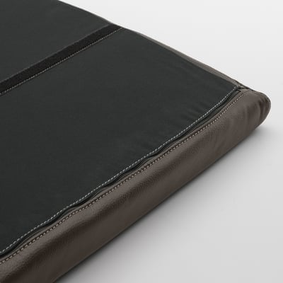 Close-up of a dark leather POÄNG footstool, showcasing its stitched seams and textured material.