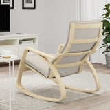 A modern light wood rocking chair with gray fabric in a cozy living space.
