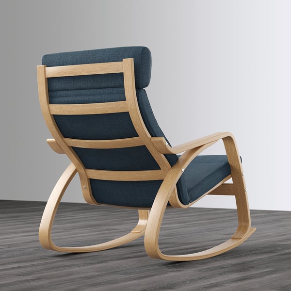 A light blue cushioned rocking armchair with a high back and wooden frame on a gray floor.