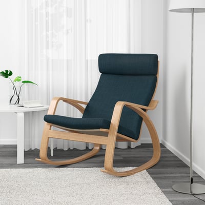 Modern rocking chair with tall back, wooden frame, blue cushions. Comfortable, resilient seat, promoting relaxation.