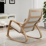 Light wooden rocking chair with light cushion in modern living room.