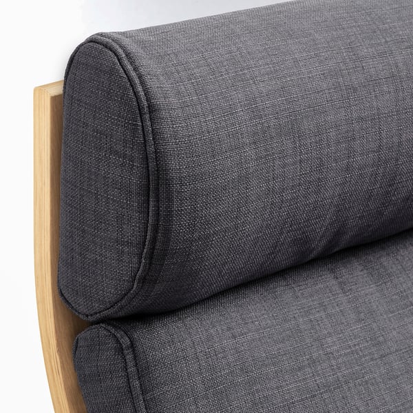 Close-up of sleek, modern sofa with curved wooden armrest and cushioned seat, highlighting quality and comfort.
