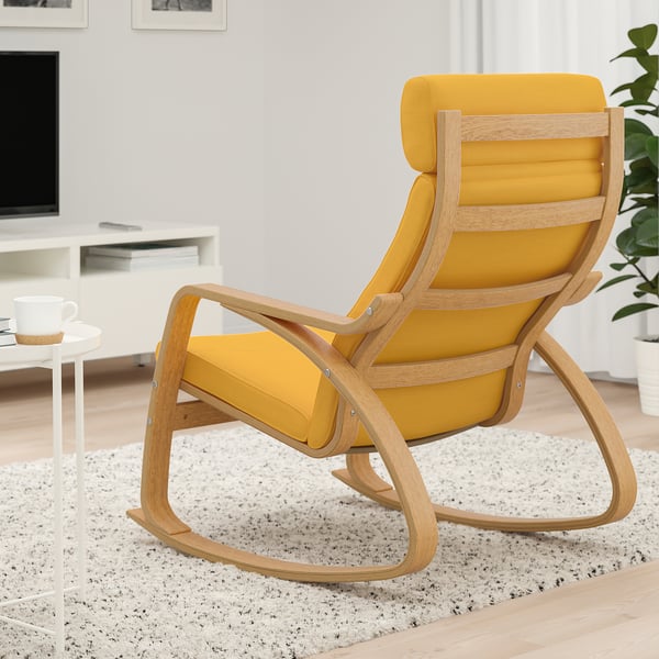 Modern living room with rocking chair, coffee table, and tv.