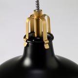 Black pendant lamp with golden metal accents, striped cord, and adjustable design. High-quality materials and craftsmanship for durability.